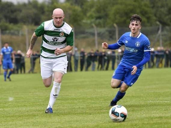 Cockhill Celtic's experienced midfielder, Gerry Gill wins this race for the ball ahead of Limerick player Colm Walsh-O'Loghlen at the Charlie O'Donnell Sports Grounds.