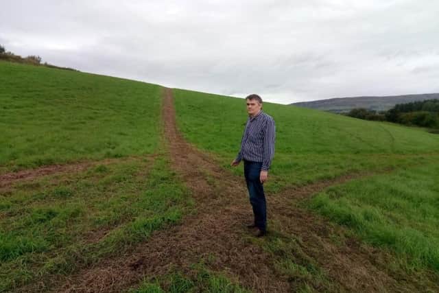 Mr. McCloskey at the centre-point of an impromptu race track quad-biking vandals tore into his uncut silage at the weekend.