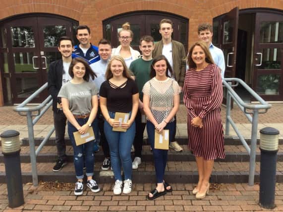 Limavady Grammar School Year 14 pupils who achieved 3 or more A/A* grades in their A level exams pictured with Principal, Nicola Madden.