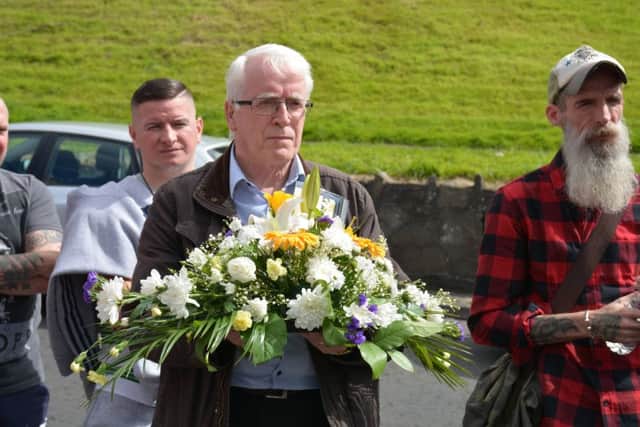 John Kelly presenting flowers at the memorial.