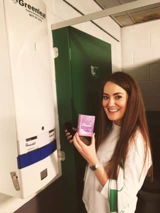 Mikaela McKinley with the newly installed machines for free sanitary products at Celtic Park