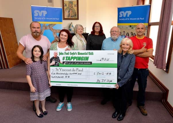 Members of the Coyle family present a cheque for Â£5412.58, the proceeds from the recent JP Coyle Memorial Walk, to Saint Vincent De Pauls Sally Kennedy at the Bridge Street charitys offices. Included in the photograph are SVDP members Dominic Burke, Catherine Moore and Sean Gallagher. DER3518GS023