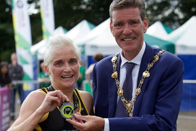 Strabanes Ann MarieMcGlynn is congratulated on her third Waterside Half Marathon title by Mayor of Derry City and Strabane District Council, Councillor John Boyle.