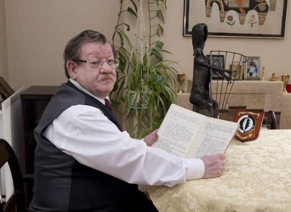Co-founder of the Civil Rights Association and veteran activist, Fionnbarra O' Dochartaigh, pictured with the first minute's book of the Derry Citizens Action Committee and Dr Conn McCluskeys Harpist sculpture Civil Rights Memorial award.  DER3618GS017