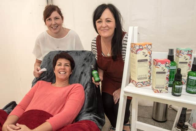 Chamber of Commerce President Jennifer McKeever enjoys a relaxing facial in the SO27 mini spa with Beauty Therapist Debbie McCormick, left and SO27 founder Deborah Lamberton.