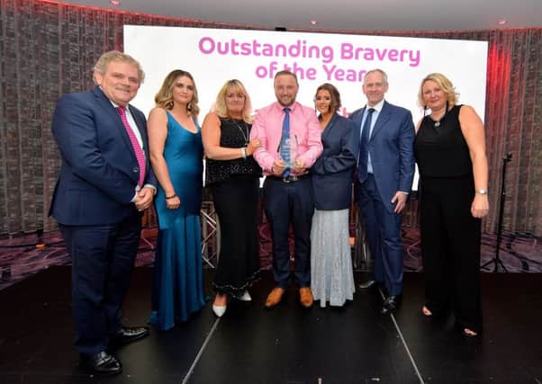 The Johnston family collect the Outstanding Bravery of the Year Award, posthumously awarded to Alexandra Johnston, who lost her battle with cancer earlier this year.  Included in the photograph are compere Adrian Logan, Grainne Toland, marketing manager of sponsor Taggart Homes, Paul McLean, managing director of principal sponsor BetMcLean, and Andrena OPrey, Johnston Press. DER3618GS066