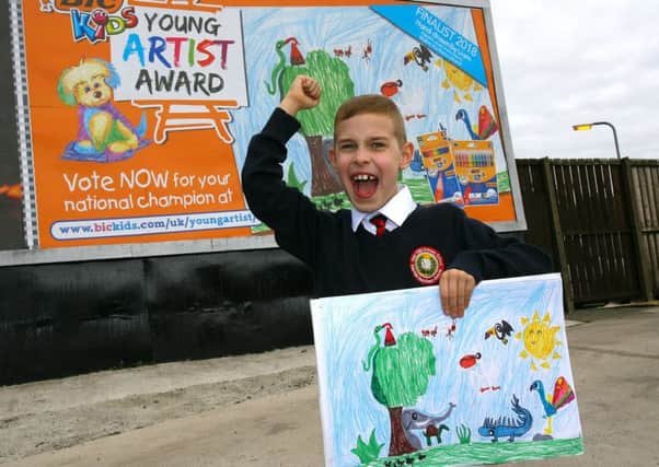 Liam Dornan (8) from Derry, regional winner for Northern Ireland of the BIC KIDS Young Artist Award with his artwork  and one of the billboards on which it is displayed. Photo: Professional Images/@ProfImages