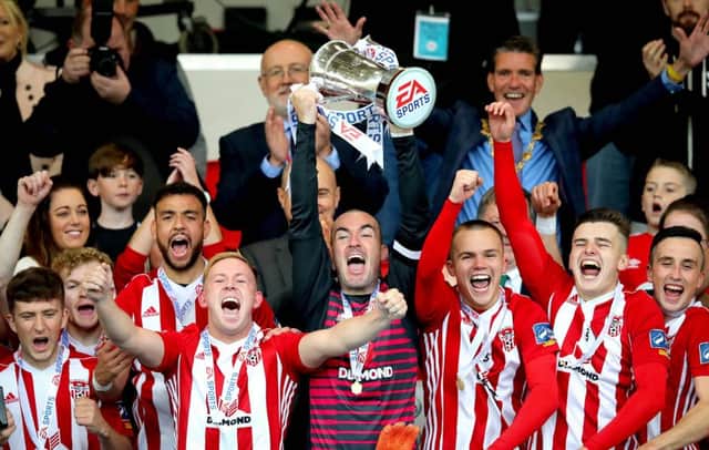 Derry's Gerard Doherty lifts the trophy