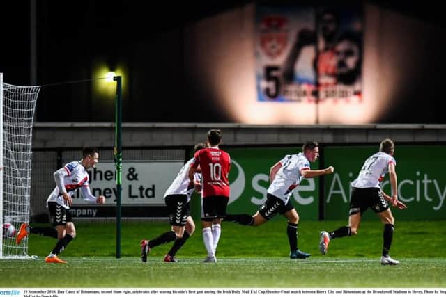 Dan Casey celebrates putting Bohs in front with a mural of Ryan McBride in the background.