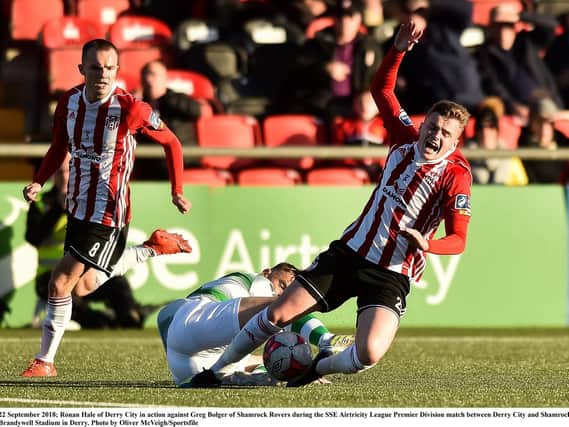 Derry City striker, Ronan Hale feels the full force of Greg Bolger's tackle during Saturday's league clash at Brandywell Stadium.