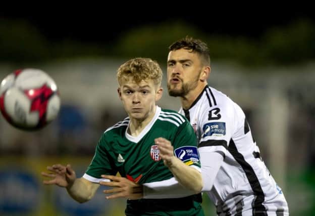 Dean Jarvis, pictured putting Adrian Delap under pressure, was one of FOUR former Derry City players involved in Dundalk's win over the Candy Stripes last Tuesday night.