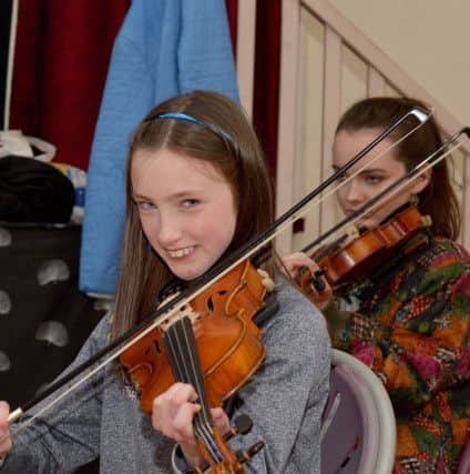 A girl from a local school plays the fiddle during the recent Fleadh Cheoil DhÃºn na nGall in Moville. DER2018GS016
