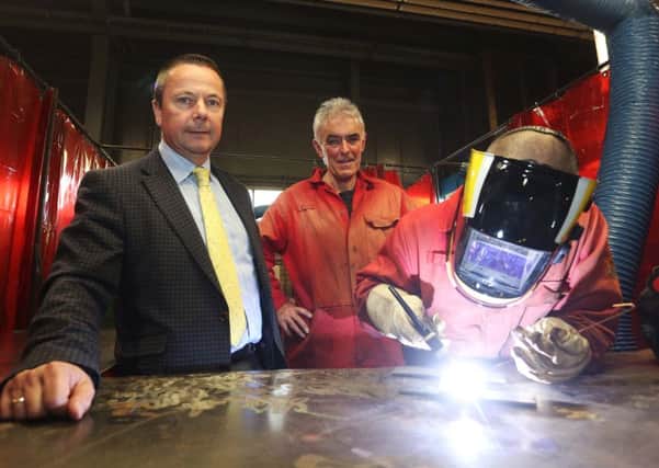 Richard Taylor, Governor of Magilligan Prison and Andy McHugh, North West Regional College tutor, along with one of the prisoners undertaking a welding course. (Photo by Lorcan Doherty)