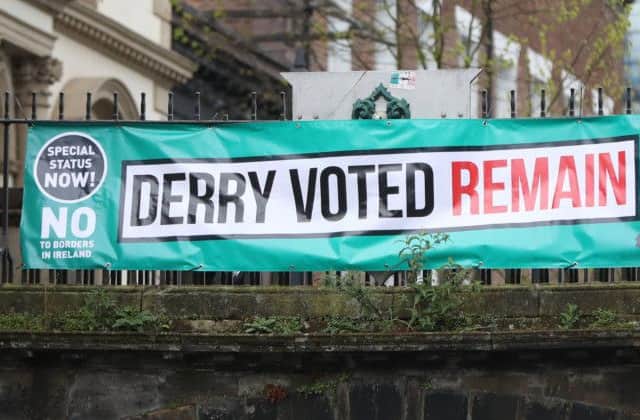 A banner reading "Derry voted remain" hung from the city's walls as the EU's chief Brexit negotiator Michel Barnier arrives to meet business stakeholders and cross-border groups at the Guildhall. (Niall Carson/PA Wire)