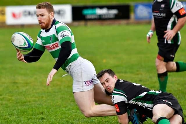 City of Derry's Simon Logue hauls down Omagh winger Neil Brown. DER4518-104KM