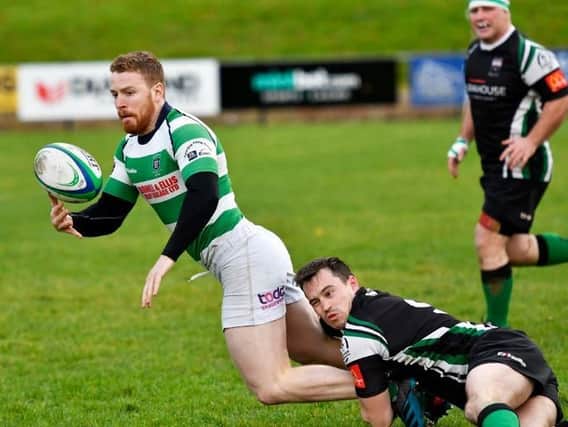 City of Derry's Simon Logue hauls down Omagh winger Neil Brown. DER4518-104KM