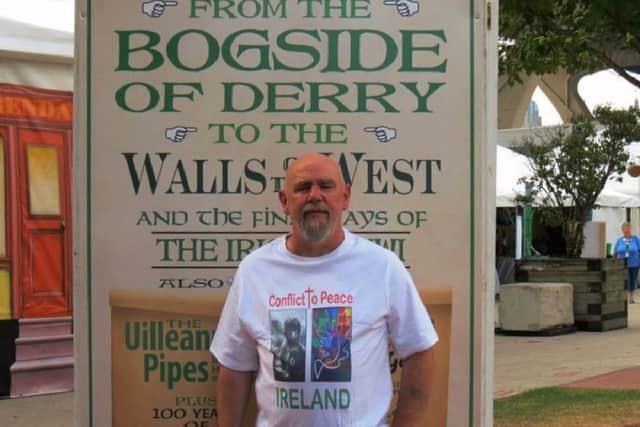 Kevin Hasson with the the Bogside Artists' exhibition ' From Conflict To Peace '  at the Milwaukee Irish Festival , the biggest Irish fest in the world.