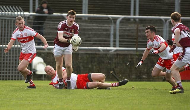 Banagher's Brian Og McGilligan gives a pass out to Tiernan Moore against Glenfin during the Ulster Intermediate Club Championship in MacCumhaill Park, Ballybofey. (Picture: Thomas Gallagher)