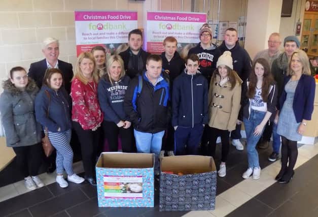John McMonagle and Deirdre McDaid from Foyle Foodbank pictured with staff and students from North West Regional College's Workskills and Retail courses during a previous appeal.