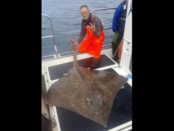 Hamish Currie pictured with the humongous eight foot long skate. (Photo courtesy of Hamish Currie)