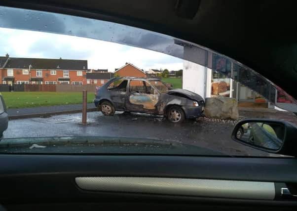 The burned out car outside the Spar shop in Galliagh.
