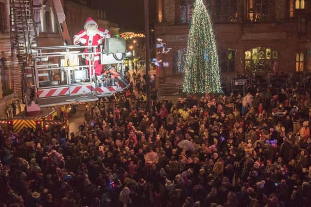 Santa flys over the crowd with the help of the Fire and Rescue Service during a previous Christmas Lights Switch on in Derry's Guildhall Square. Picture Martin McKeown. Inpresspics.com.