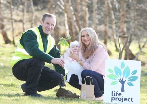 Jane Deeney with Derry City and Strabane District Council Park Ranger Frankie Quigley planting a Life Project tree at Ballyarnett Country Park to mark the registration of the birth of her daughter Emilia.