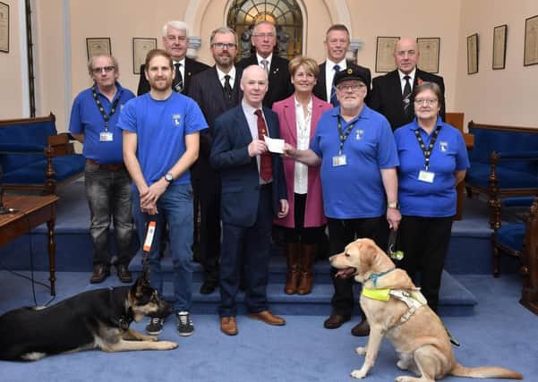 Reggie and Grace Downey pictured handing over a cheque for Â£4,270.00, proceeds from a sponsored cycle from Londonderry to Donegal Town by Masonic Lodge members from the North West, in memory of their daughter Rachel, to Norman Lyttle, Chairman of the Maiden City Branch of Guide Dogs NI, one of the charities that Rachel volunteered for. Included are, from left, front row, Nigel Anderson, volunteer, Tim Atkinson, Mobility Instructor, Guide Dogs NI, and Pamela Lyttle, Secretary of the Maiden City Branch, and guide dogs Voss and Bertie, back row, Noel Drain, Provincial Grand Master, Provincial Grand Lodge of Freemasons Londonderry and Donegal, Stuart McCarter, Raymond Robinson, Colin McCandless and John Cairns. DER4518-101KM