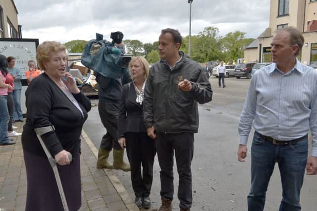 The Taoiseach Leo Varadkar,  Regina Doherty  and Joe McHugh chat with local woman Mary Farren (left), from Malin Street, during their  flood inspection visit to Carndonagh after the floods of August 2017. DER3417GS58
