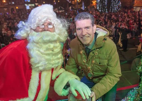 The Mayor Councillor John Boyle helps Santa to switch on the Chrismas lights in Strabane on Saturday.