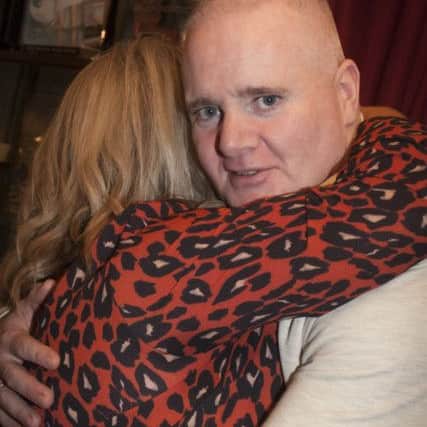 Derry Republican Tony Taylor gets a hug from his wife Lorraine after arriving home at his parents Creggan home on Wednesday night.