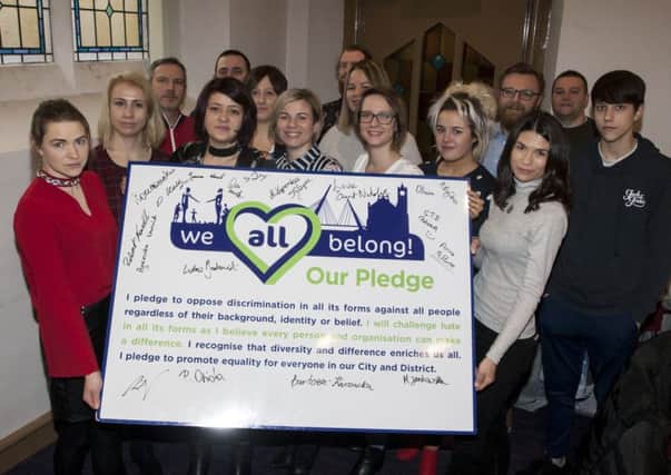 Members of Polish Abroad community sign the pledge to tackle prejudice and hate crime â¬ÜWe All Belong!â¬" Our Pledge at the Unison Building, Clarendon Street, Derry this week.