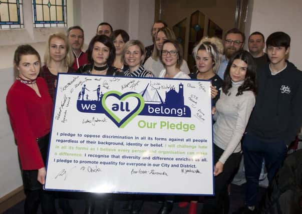 Members of Polish Abroad community sign the pledge to tackle prejudice and hate crime Ã¢Â¬ÃœWe All Belong!Ã¢Â¬" Our Pledge at the Unison Building, Clarendon Street, Derry this week.