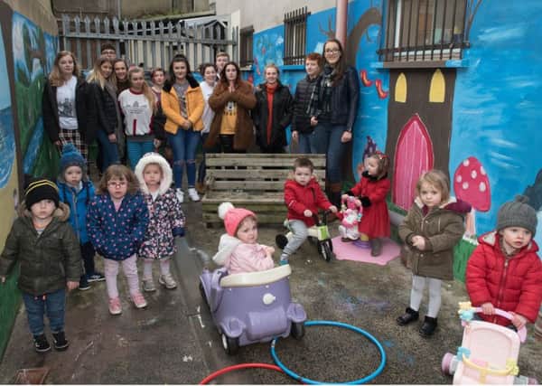 North West Regional College Art students pictured with some of the children from the Dry Arch Centre in Limavady as they get the first glimpse of their new playground.  (Picture Martin McKeown).