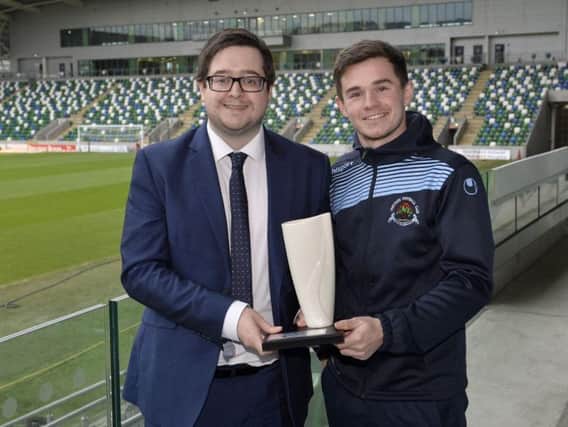 Institute striker Michael McCrudden collects his Belleek Player of the Month trophy from NIFWA Chairman Keith Bailie.