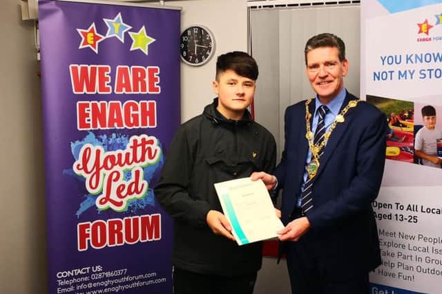 Wiktor Wroniak receives his certificate from the Mayor of Derry & Strabane Councillor John Boyle
