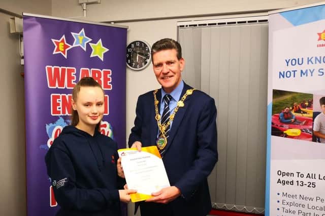 Mia Brolly receives her 'Save Your Mate' certificate from Mayor of Derry & Strabane Councillor John Boyle