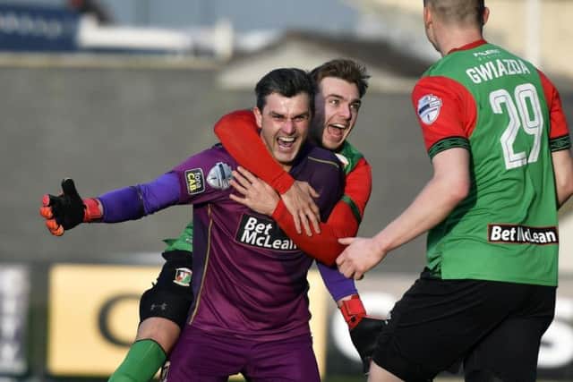 Glentoran keeper Elliott Morris is mobbed by his team-mates after his goal against Institute at the Brandywell. DER0319-106KM