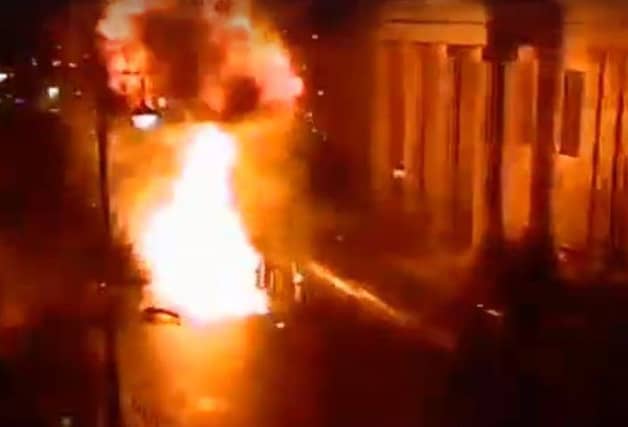 The car on fire outside the courthouse immediately after the explosion, as captured on CCTV cameras in the area.