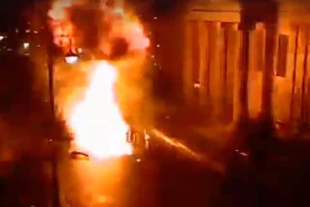 The car on fire outside the courthouse immediately after the explosion, as captured on CCTV cameras in the area.