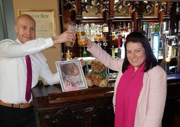 Kevin Hegarty and Carla Devine raising a toast in memory of their cherished baby girl following her funeral