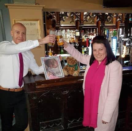 Kevin Hegarty and Carla Devine raising a toast in memory of their cherished baby girl following her funeral