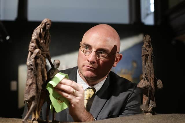Ryan Mahoney, Director of Irelands Great Hunger Museum with Rowan Gillespies  Statistic I and Statistic II, 2010, at the Coming Home: Art and The Great Hunger exhibition in the Glassworks.