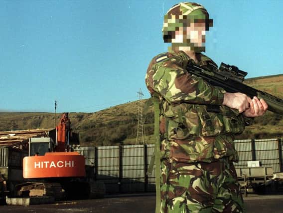 A British soldier stands guard for the last time at Fort Whiterock Army Base in West Belfast in 1999 as bulldozers moved in to dismantle the remains of the 20 year-old base which had been home to more than 7,500 troops and witnessed some of the worst of the Troubles. (Photo: Pacemaker)