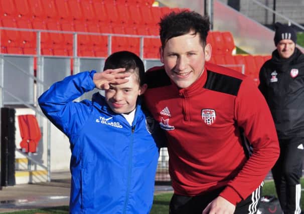 Adam Morrison pictured alongside his favourite player Conor McDermott, before training got underway on Sunday morning.