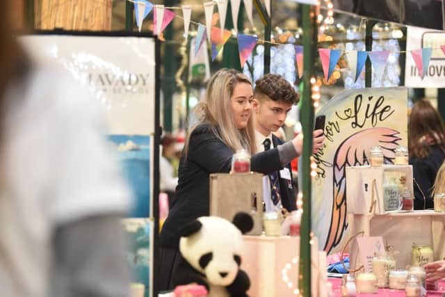 Students take pictures of the Lights for Life candles, created by the Young Enterprise team in Lisneal College, Derry