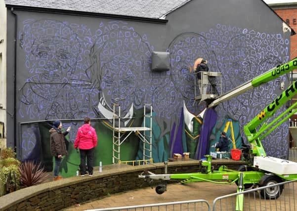 Work began yesterday on large mural of the Derry Girls on the side of Badgers Bar on Orchard Street. Locally based UV Arts will immortalise the main characters Erin, Orla, Clare, Michelle and James in paint over the next couple of days. DER0419GS-021