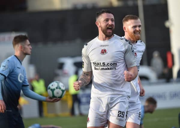Crusaders Rory Patterson celebrates after scoring at Institute, on Saturday.