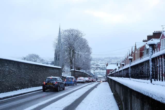 Traffic backed up on Creggan Road in Derry on Wednesday following the heavy snow showers. (Picture by Lorcan Doherty / Press Eye)