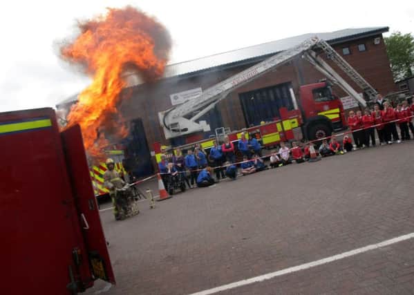 Local children previously being shown the dangers of a chip pan fire during an Open Day at Crescent Link Fire Station. DER2315MC062